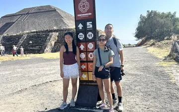 Family by a signpost at the Teotihuacan pyramids in Mexico