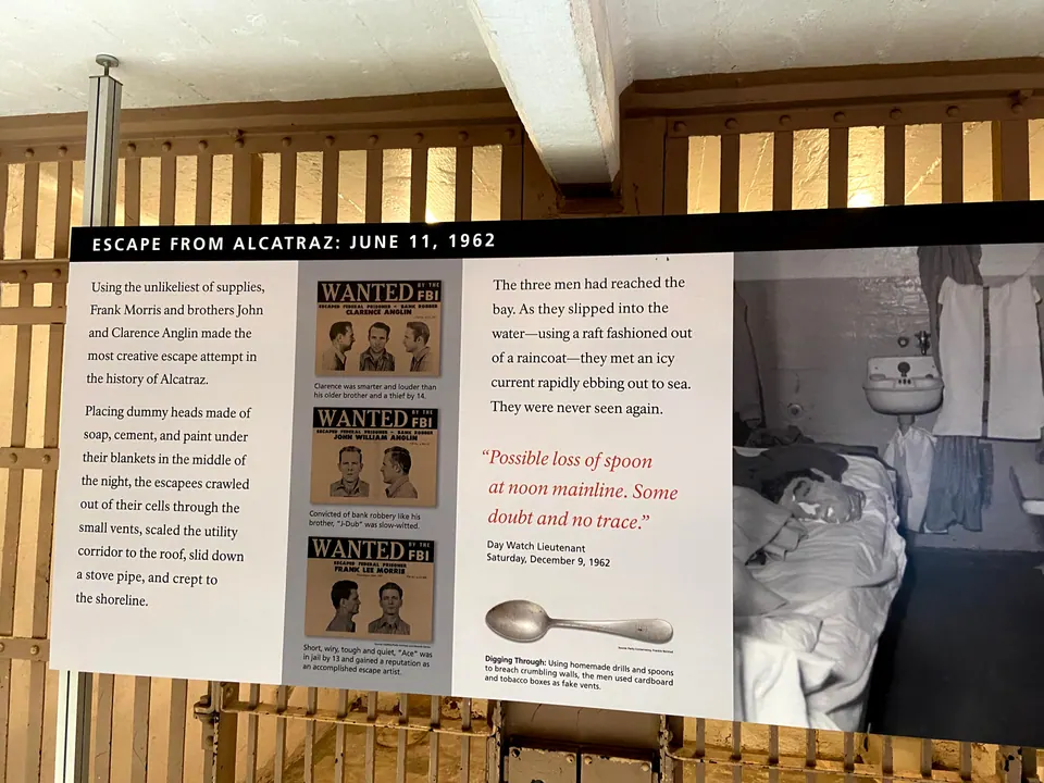 An exhibit panel titled Escape from Alcatraz with wanted posters, a spoon and a photograph of a dummy head on a bunk.